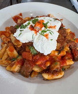 Cavatelli with a Braised Beef Ragu topped with a scoop of ricotta