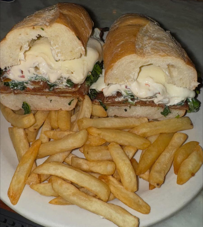 Eggplant Hero, Fried eggplant, broccoli rabe, provolone with a ricotta cherry pepper spread served with a side of fries.