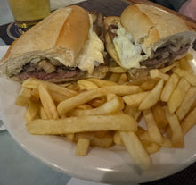 Grilled Steak Hero Thinly cut and grilled steak on garlic bread topped with melted provolone, mushrooms and onions served with a side of fries. 