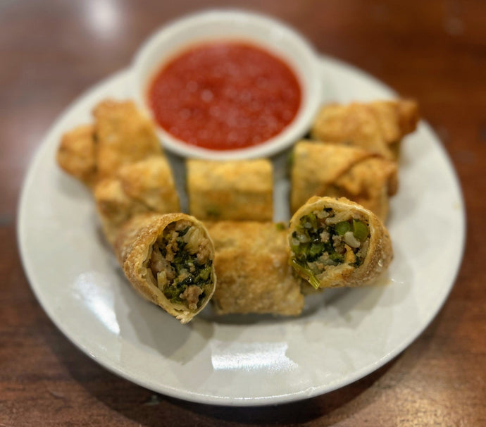 Italian Eggrolls - eggrolls stuffed with sausage, broccoli rabe and rice served with a side of marinara sauce.