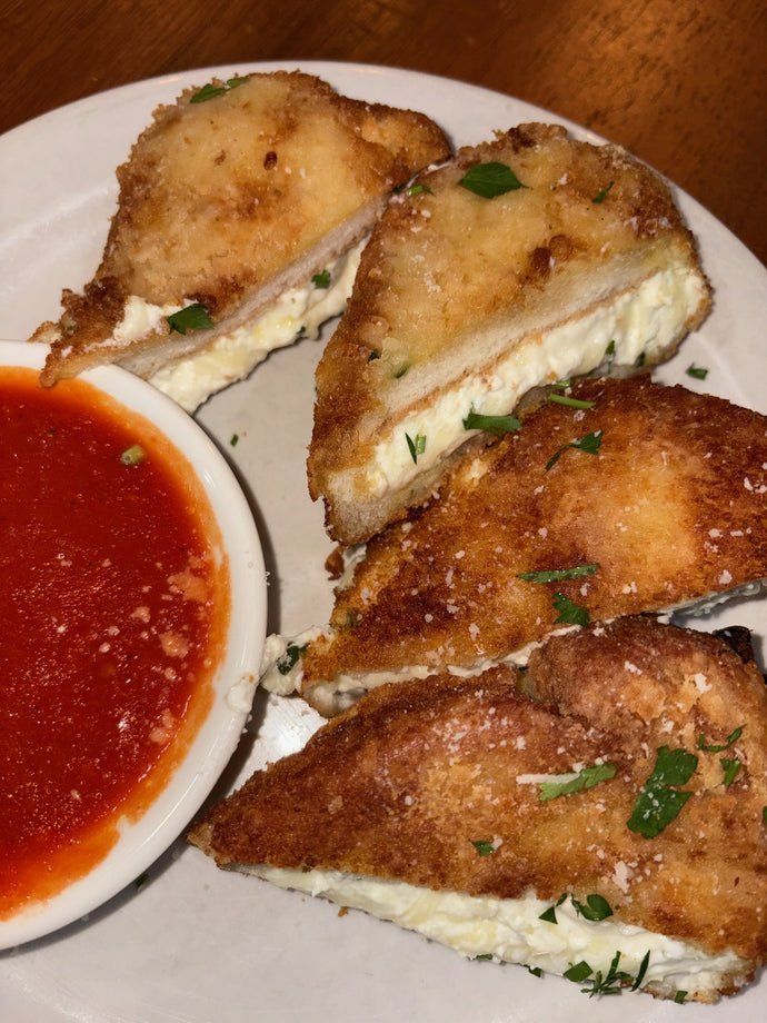 Mozzarella en Carrozza Pan fried bread stuffed with mozzarella and ricotta