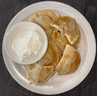 Jimmy Max Perogies with sautéed onions and a side of sour cream